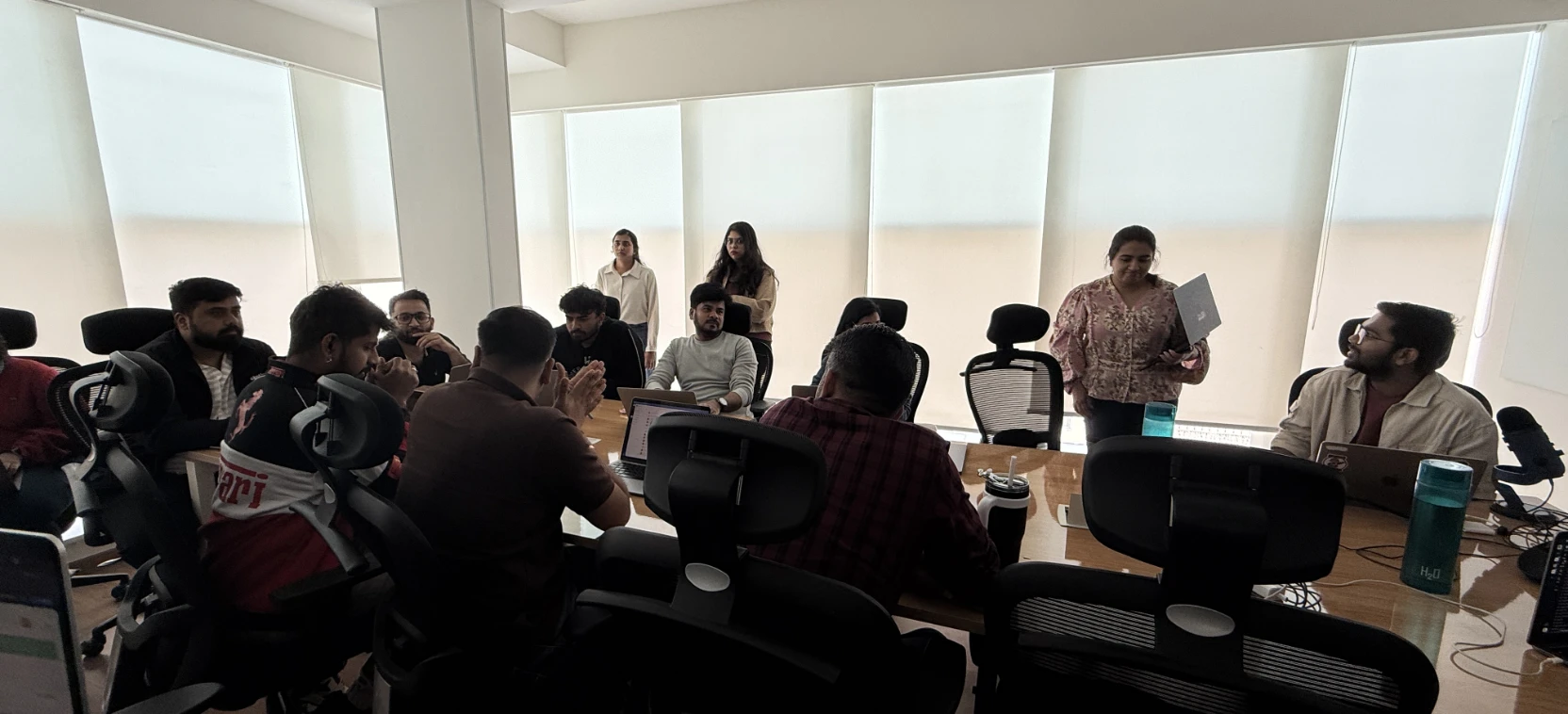 The observed workshop. The design team around a meeting table, working through their own campaigns.
